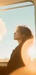 a woman with her head up looking out the window