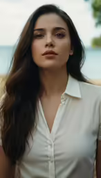 a beautiful young lady with long hair posing in front of the beach