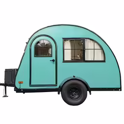 the small teary camper is sitting in the open