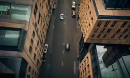 a view from above looking down at the cars driving on a city street