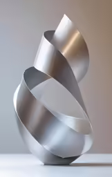 an abstract sculpture is shown with a large, wavy object in the background