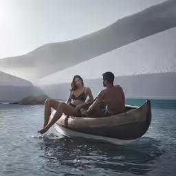 a couple sitting in an igloose on the lake