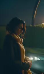 woman holding light up her phone near the street