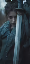 a girl holding a sword in her hand