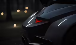 a black sports car with bright lights on its rear bumper