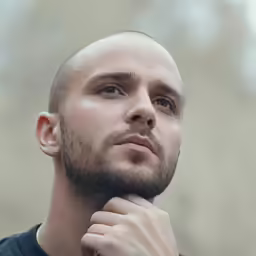 a man that has a bald head and a beard
