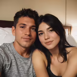 the couple is lying down together in bed