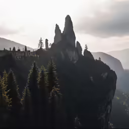 a mountain covered in a forest with a castle on top