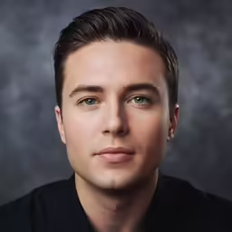 a man with blue eyes wearing black shirt