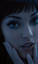 a woman with her hands to her face, with blue eyes and black hair