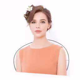 a beautiful woman in an orange top and white flower in her hair