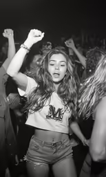 black and white photograph of a woman dancing at nightclub