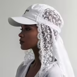 a woman with a white veil and head covering on her head