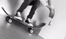 black and white photo of a person on a skateboard