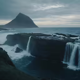 a waterfall with a rock in the middle of it