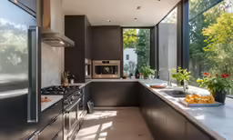 a kitchen with glass windows overlooking a beautiful park