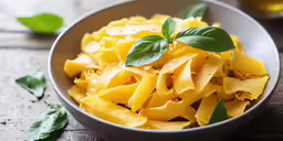 the pasta is made up of yellow noodles and basil