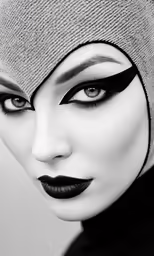 the woman in the turban is wearing black lips