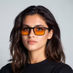 woman wearing a black sweater and sunglasses looking at the camera