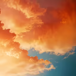 some orange and yellow clouds are in the sky