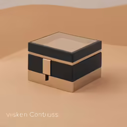a jewelry box with a black lid on the sand