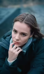a beautiful young woman posing on a bench