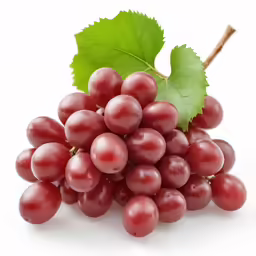 a bunch of red grapes with a leaf on it