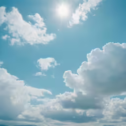 the clouds are in the blue sky above