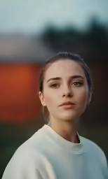 the girl is wearing white clothes outside in the day