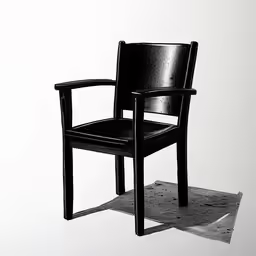 black chair on the ground with one arm folded