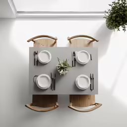 a table set for two on wooden chairs