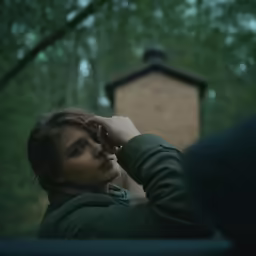 young woman with eyes closed in a wooded area