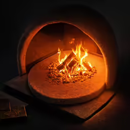 a hot coal oven with fire and rocks on top