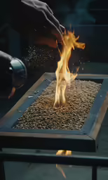 an open metal box on fire with fire coming out