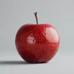an apple with drops of water on it