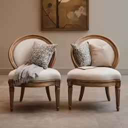 a room with two chairs and pillows on the floor