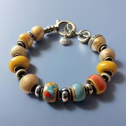a colorful bracelet on top of a table,a multicolored bracelet is on display on a blue background
