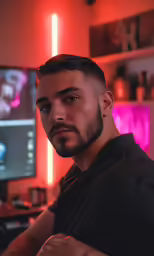 a man in the dark stares ahead at something