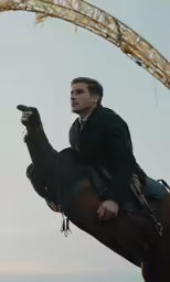 a man sitting on top of a horse