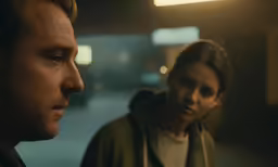 a man and woman in a room next to each other