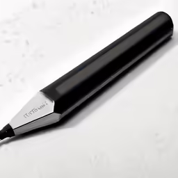 a black pen sitting on top of a white counter