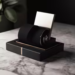 a close up of a black object with a black and gold ring on it
