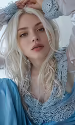 a woman in a blue dress poses for a photograph