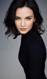 a woman posing for a photo wearing black