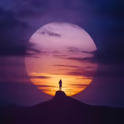 a person standing on top of a mountain at night with the moon in the background