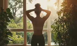a person who is sitting and has their hands on his head
