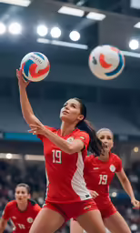 some girls in red are playing volleyball on a court