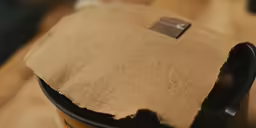 a brown piece of paper is in the shape of a canister