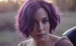 an adorable young woman with purple hair with a field in the background