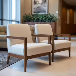 two beige upholstered chairs in a waiting area